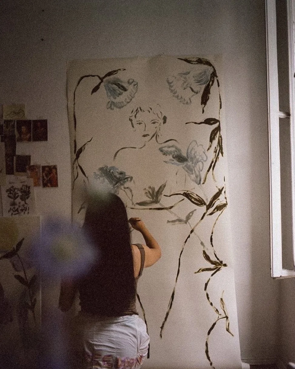 A first mark made on a hung length of cloth at a painting evening in London for women